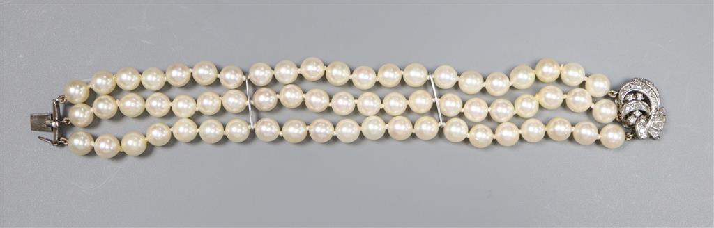 A triple strand cultured pearl bracelet, with diamond set white metal clasp, 17.5cm, gross 38.7 grams,